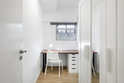 a man is standing in front of a screen with icons at Smart Stay in Gaia | Cozy & Work-Ready in Vila Nova de Gaia