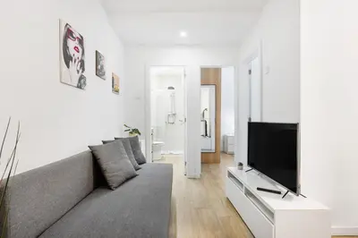 a kitchen with white counters and a white table at Smart Stay in Gaia | Cozy & Work-Ready in Vila Nova de Gaia