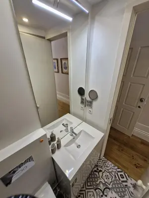 a bathroom with a white sink and a mirror at Alma Porto in Porto