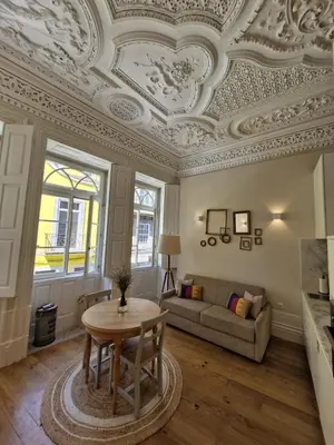 a living room with a coffered ceiling and a table at Alma Porto in Porto