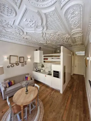 a living room with a coffered ceiling and a table at Alma Porto in Porto