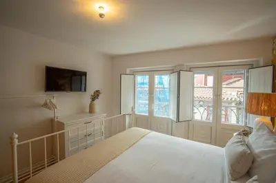 a bedroom with a white bed and a window at The Medievel in Porto