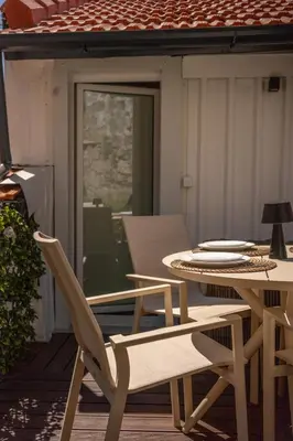 a table and chairs sitting on a patio with a table and a table and chairs at The Medievel in Porto