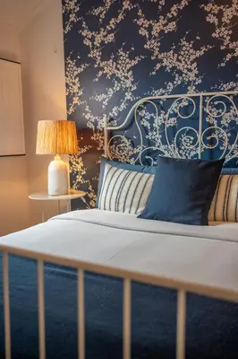 a bedroom with a bed with a blue and white wall at The Medievel in Porto