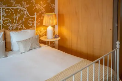 a bedroom with a white bed and a lamp at The Medievel in Porto
