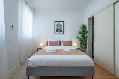 a bedroom with a large bed with two towels on it at Oporto Maria Pia Suite 1 in Porto