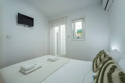 a white bedroom with a bed with towels on it at Oporto Maria Pia Apartment Whith Terrace 2 in Porto