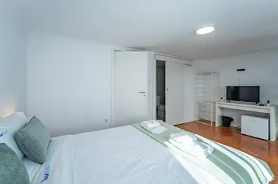 a bathroom with a toilet and a sink and a shower at Oporto Maria Pia With Terrace Suite 4 in Porto