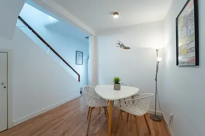 a bedroom with a white bed and a desk at Oporto Maria Pia With Terrace Suite 4 in Porto
