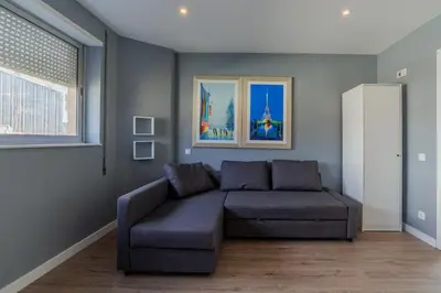 a living room with a couch and a window at Your Home at Porto in Porto