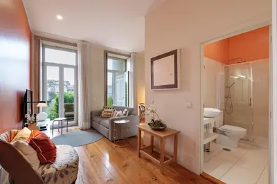 a living room with a couch and a bathroom at VIVA Breiner Chic Apartment in Porto