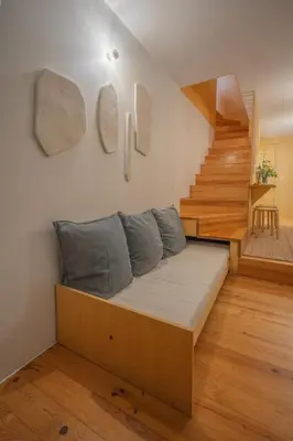 a bed in a room with a stair case at Belmont Riverside 5m in Porto