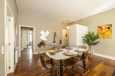a dining room with a white table and chairs at Cardosas Square Living in Porto