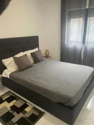a large bed in a bedroom with a window at Candal house in Vila Nova de Gaia