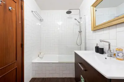 a bathroom with a tub and a sink and a shower at NEW! The Porto Wine Cellars Penthouse in Vila Nova de Gaia