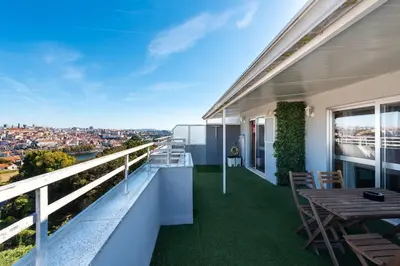 a balcony of a house with a table and chairs at NEW! The Porto Wine Cellars Penthouse in Vila Nova de Gaia