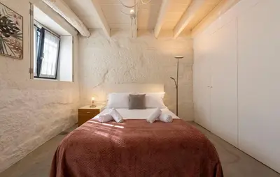 a bedroom with a large bed with a red blanket at NEW! Blue Pearl Apartment in Porto