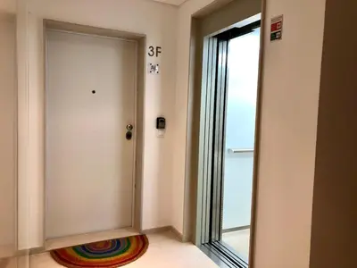 a door with a rainbow rug next to a window at Sunny rooftop duplex with elevator near iconic bridge in Vila Nova de Gaia
