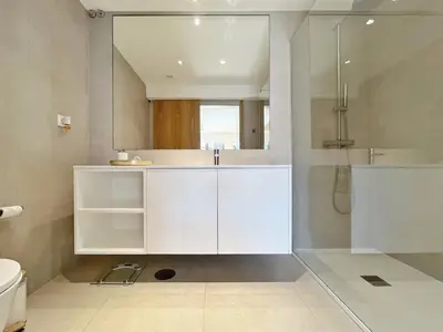 a white bathroom with a shower and a toilet at Sunny rooftop duplex with elevator near iconic bridge in Vila Nova de Gaia
