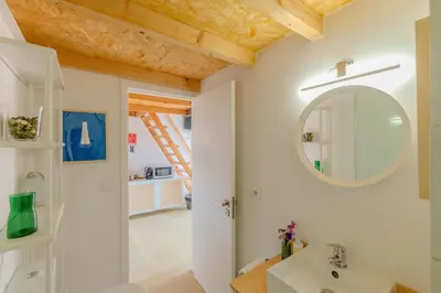 a bathroom with a mirror and a sink at VIVA Fontainhas Houses in Porto