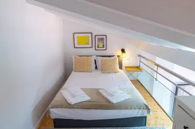 a bedroom with a bed with two towels on it at VIVA Fontainhas Houses in Porto