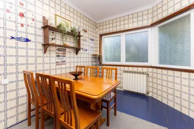 a dining room with a wooden table and chairs at Home Sweet Home in Porto