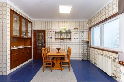 a dining room with a wooden table and chairs at Home Sweet Home in Porto