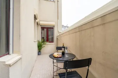 a small patio with a table and two chairs at Modern & Cozy Flat with Workspace by HostWise in Porto