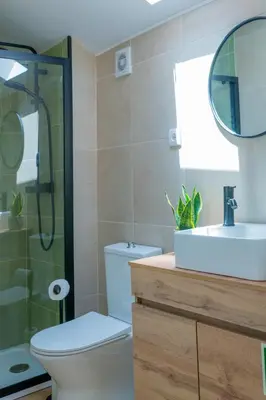 a bathroom with a toilet and a sink and a shower at VIVA Boavista Duplex Retreat in Porto