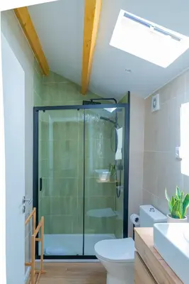 a bathroom with a glass shower and a toilet at VIVA Boavista Duplex Retreat in Porto