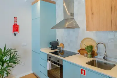 a kitchen with a sink and a stove at VIVA Boavista Duplex Retreat in Porto
