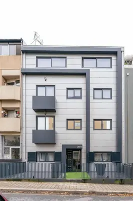 a large white building with windows on it at Sleek Apartment with Balcony by HostWise in Porto