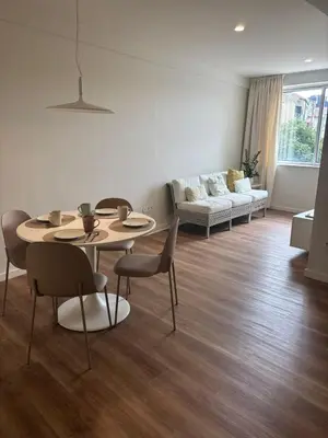 a living room with a table and chairs and a couch at Esmeralda Porto in Porto