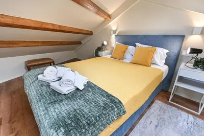 a bedroom with a bed with towels on it at Cosy HouseTypical Space in Porto by Su e Luís in Porto