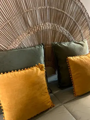 a bench with three pillows and a wickerigunigunigun at Cosy HouseTypical Space in Porto by Su e Luís in Porto