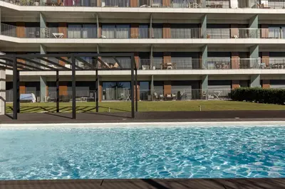 a swimming pool in front of a building at Antas Park with pool and gym - to work & leisure in Porto