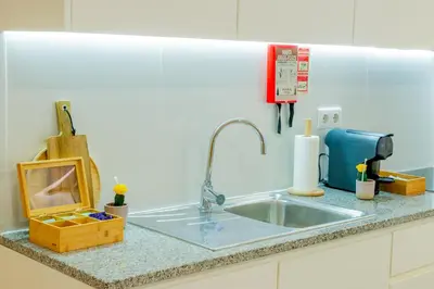 a kitchen counter with a sink and a phone at VIVA República Serviced Apartment in Porto
