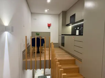 a kitchen with a staircase leading to a dining room at Pinheiro Houses's- Luxury Apartment's by Oporto Soul in Porto