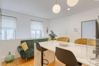 a white living room with a table and chairs at OPORTO GUEST São Brás 66 in Porto