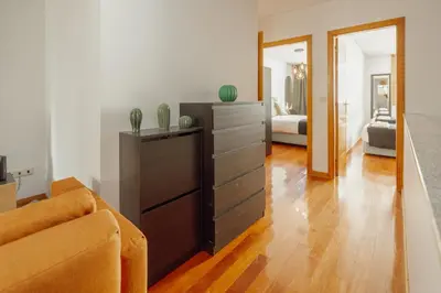 a living room with a couch and a dresser at Modern Terrace 2BD Apartment by Vacationy in Porto