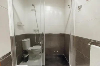 a bathroom with a toilet and a glass shower at Modern Terrace 2BD Apartment by Vacationy in Porto