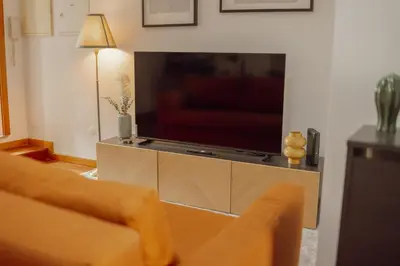 a living room with a large flat screen tv at Modern Terrace 2BD Apartment by Vacationy in Porto