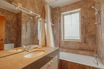 a bathroom with a sink and a shower and a window at Botanic Garden Terrace Apartment by Vacationy in Porto