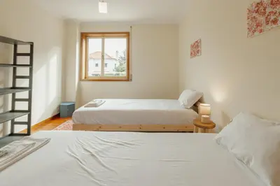 a bedroom with two beds and a window at Botanic Garden Terrace Apartment by Vacationy in Porto