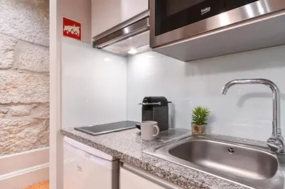 a kitchen with a sink and a microwave at ON Apartments - Free Parking & Pet Friendly in Porto