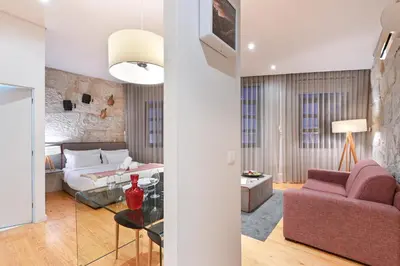 a living room with a bed and a couch at ON Apartments - Free Parking & Pet Friendly in Porto
