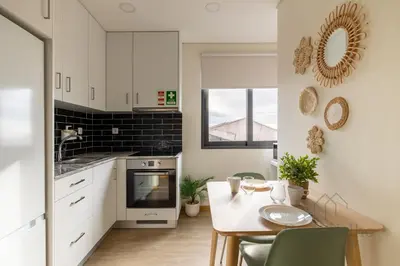 a kitchen with a table and a dining room at Gloria in Porto - Porto Velho Apt in Porto