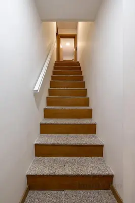 a staircase in a building with wooden steps at Gloria in Porto - Porto Velho Apt in Porto
