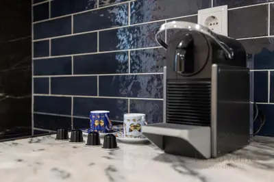 a kitchen counter with a toaster and two cups at Gloria in Porto - Porto Velho Apt in Porto