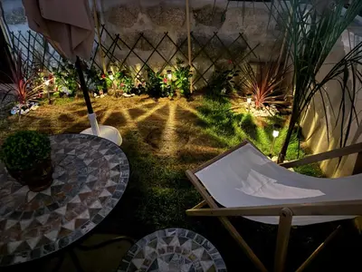 a backyard with a table and chairs and lights at CreaConfort Casa Boa Jóia de Campanhã in Porto